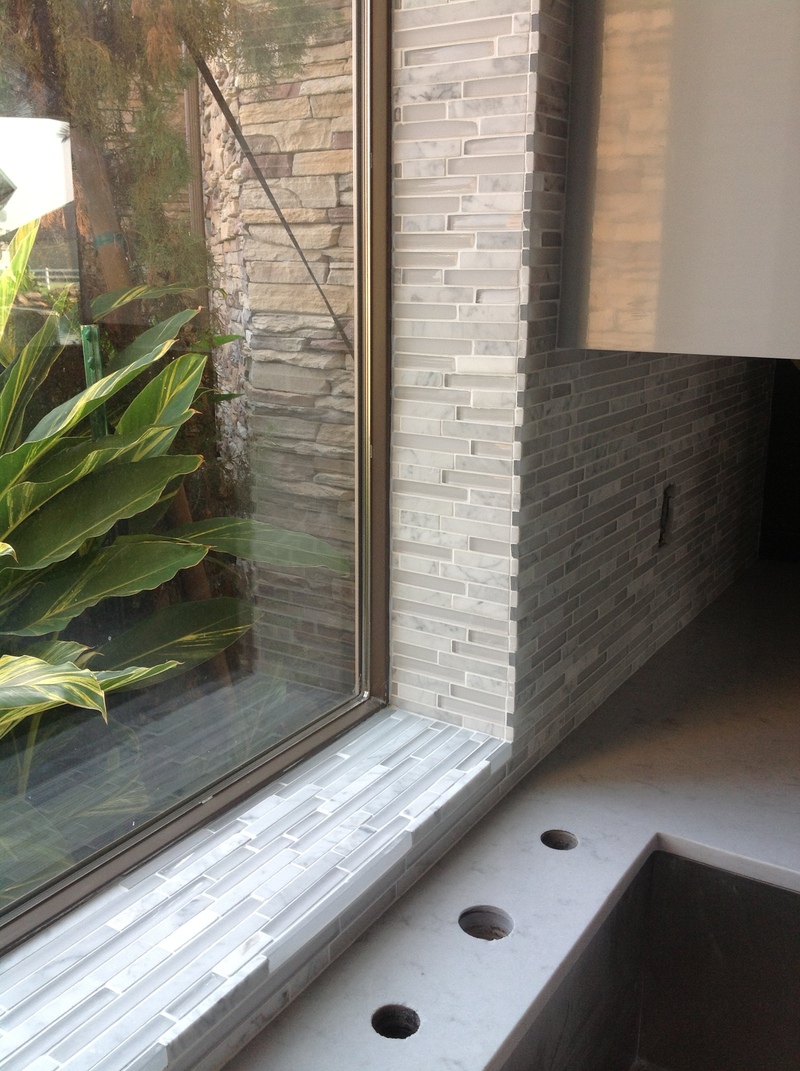 CUSTOM TILE WAS CUT AND TURNED INTO WINDOW SILL LEAVING NO RAW EDGES
